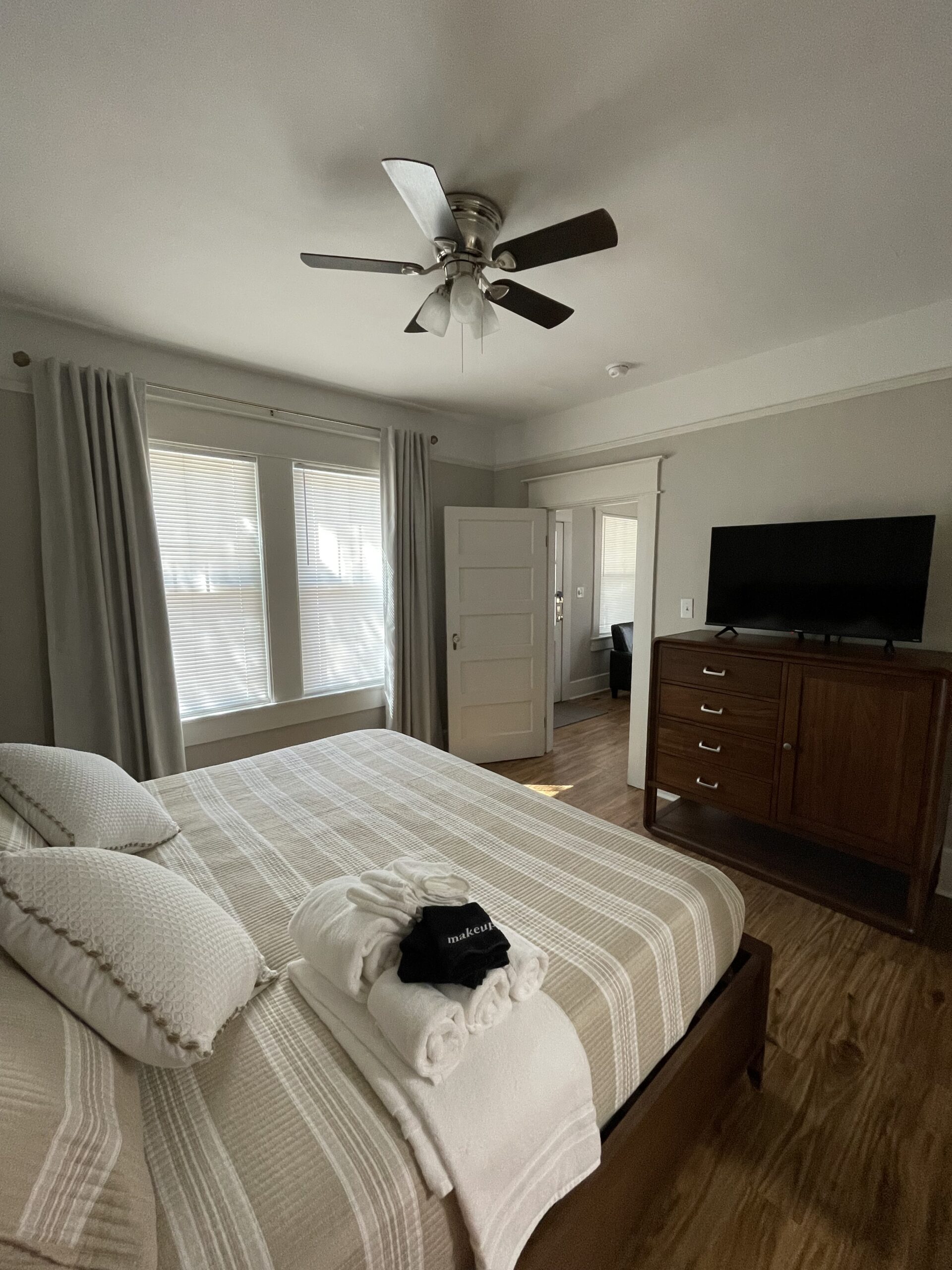 Spotless Airbnb bedroom with fresh linens, showcasing our attention to detail in cleaning.